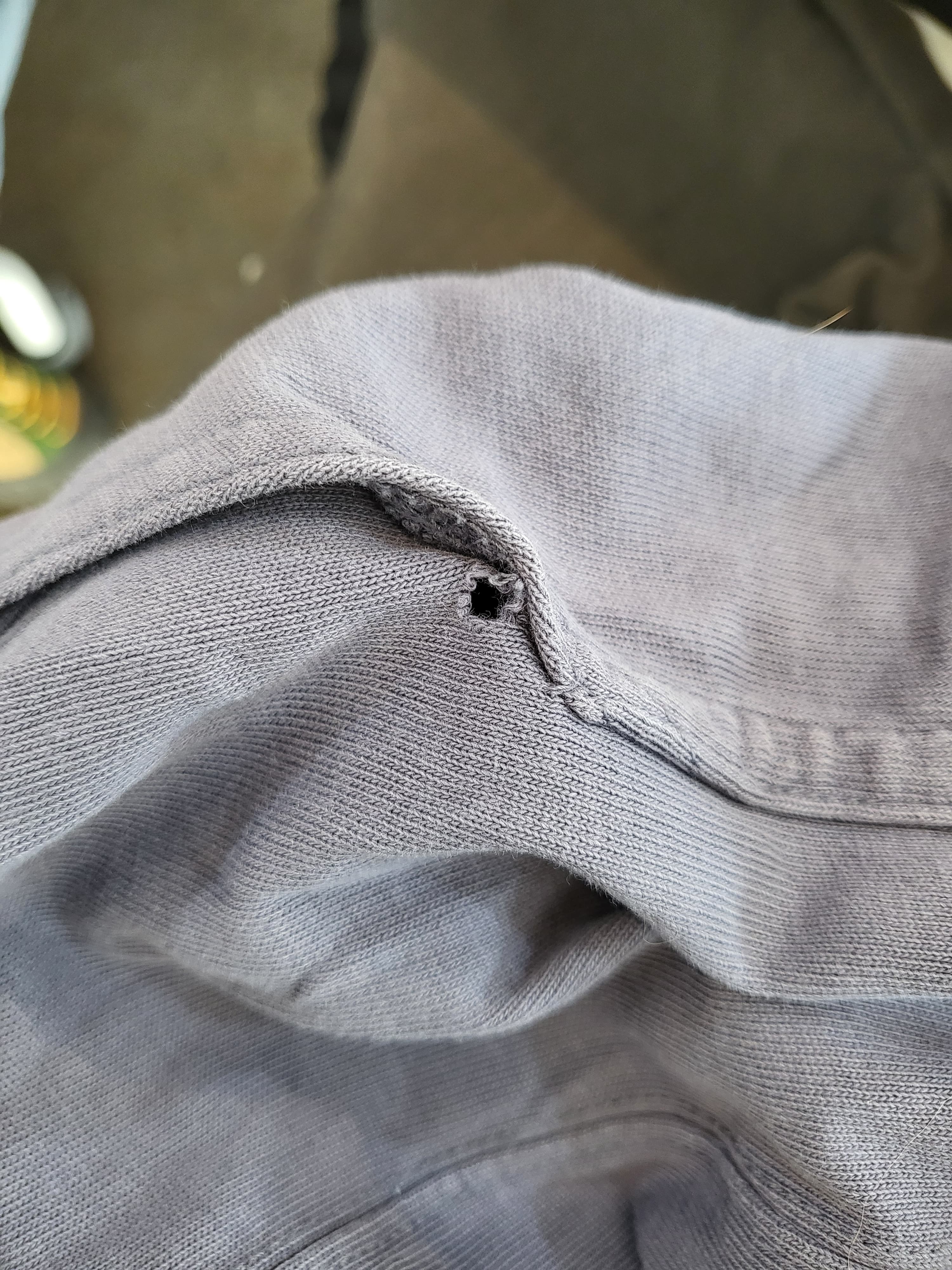 Hole near the yoga pants pocket opening — before repair