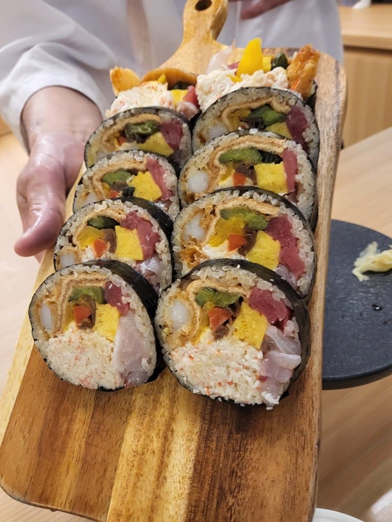 Futomaki cross-section — layers of tuna, flounder, shrimp, tamagoyaki