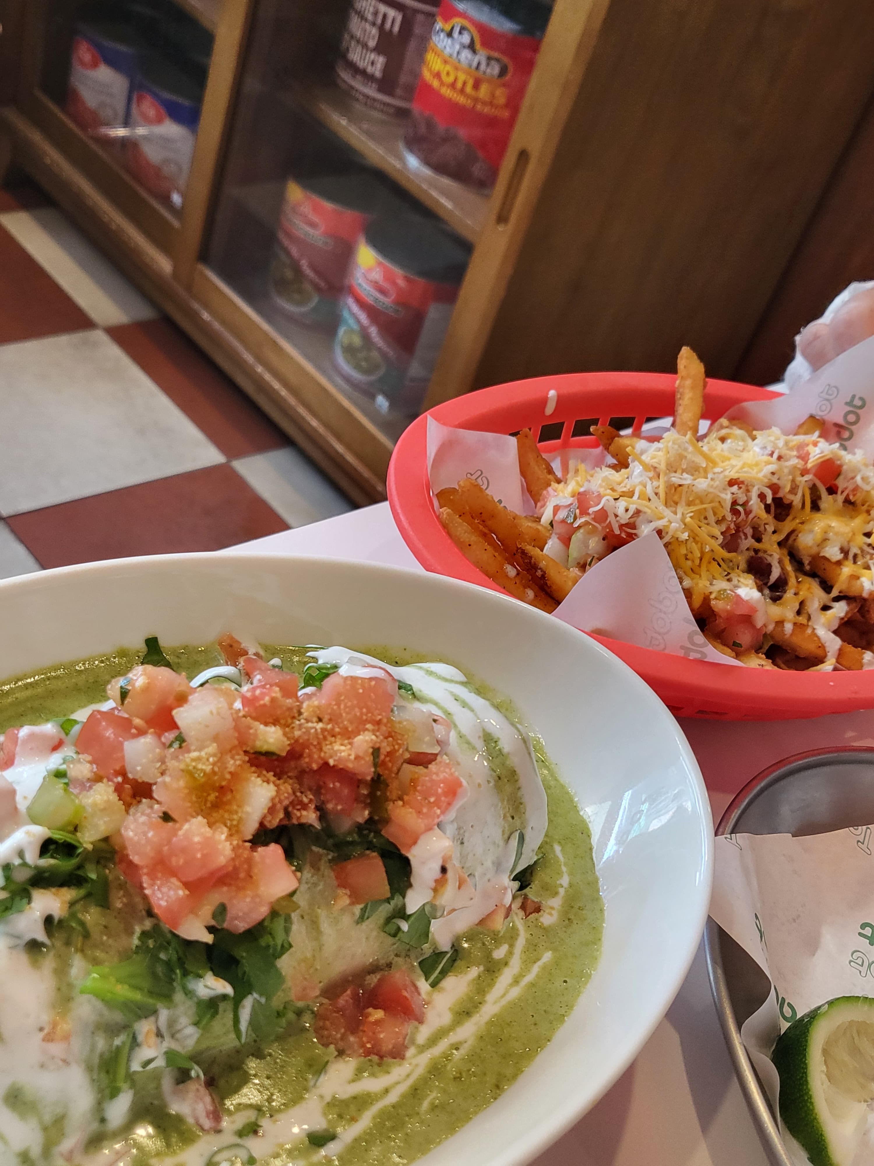 Tacodot — Charlie cheese fries and verde enchilada on one table
