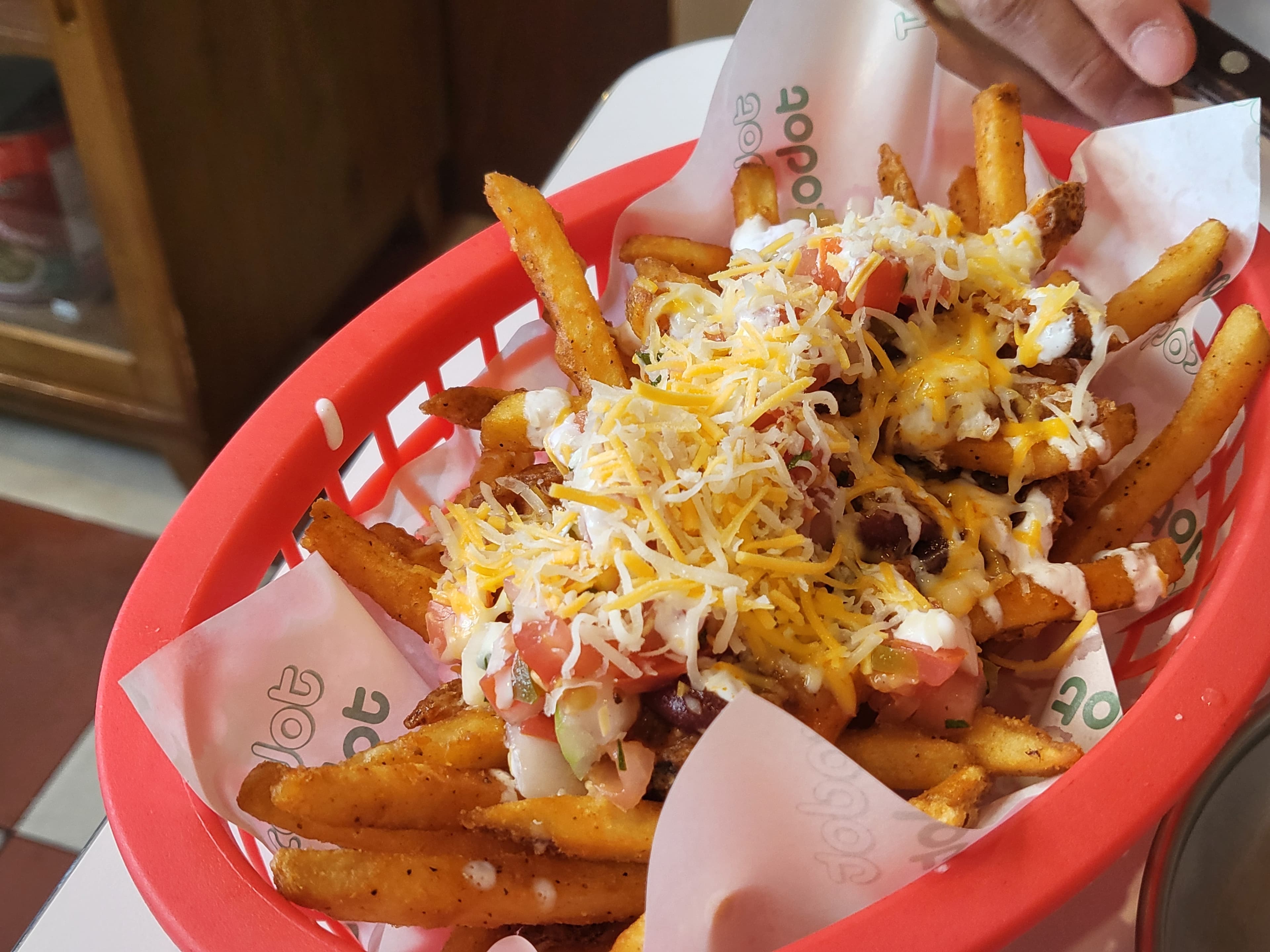 Tacodot Charlie cheese fries — cheese, beans, pico de gallo, sour cream